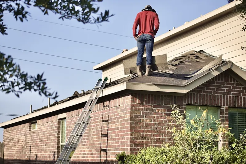 Professional roofer working on a residential roof in Wyldwood